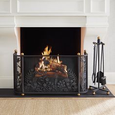 a fire place in the middle of a living room with a fireplace and two candles