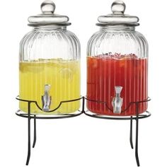 two drinks dispensers sitting next to each other on a metal stand with wire