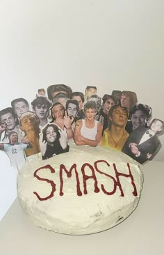 a cake with the word smash written on it in front of a group of people