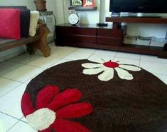 a living room with a large rug on the floor and a television in the corner