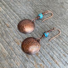 Copper dangle earrings with hand etched leaf pattern and blue sky jasper gemstone. These earrings are very light weight and perfect for everyday wear. This cool Metal Smithing method dates back over 500 years and is by far one of my favorites! Etching copper gives you some very rewarding results and adds dimension to your metal! ITEM DETAILS:  Earrings are handmade with copper components Copper etched domed circle (size of a nickel) 6mm round natural blue sky jasper Drop length is 1 1/2 inches Copper ear wire (comes with rubber stoppers) All of my pieces are sealed with Renaissance wax to prevent the copper from oxidizing. This item comes with a sheer fabric jewelry pouch for storage or gift giving. All orders are carefully packaged and shipped in a bubble envelope. Feel free to contact me Etched Metal Jewelry, Turquoise Anklet, Metal Smithing, Metal Etching, Sheer Fabric, Copper Earrings, Fabric Jewelry, Jasper Gemstone, Copper Jewelry