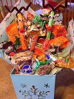 a box filled with candy and candies on top of a table next to a chair