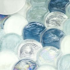 some blue and white marbles are arranged in the shape of an abstract mosaic pattern