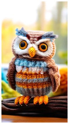 an owl figurine sitting on top of a wooden table