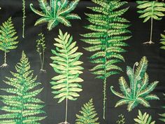 a green and black background with lots of different leaves on the same fabric as well as plants