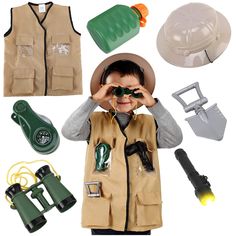 a young boy is looking through binoculars with other items surrounding him and holding his hands to his face