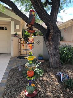 a tree that is in front of a house with many items on the top of it