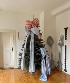 a christmas tree with bows on it in a room