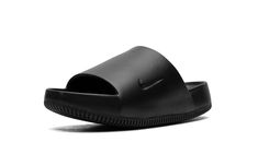 The Nike Calm Slide "Black" is a versatile, monochromatic black colorway of the comfortable slip-on sandal.  Designed for post activity wear, the Calm Slide debuted in 2023 in several appealing colorways, including in this easy-to-style “Black” design.  The sandal is constructed from a black one-piece foam mold.  The midfoot strap that supports the sandal features a debossed Swoosh on the side.  Underneath, a thick foam cushioning footbed provides a comfortable ride.