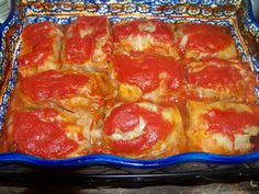 a casserole dish filled with meat and cheese covered in marinara sauces