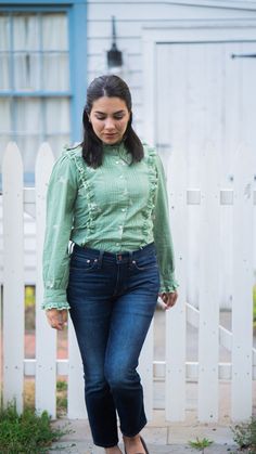 The 100% cotton blouse is a slightly fitted button up style in a beautiful green tone with the best selling Poppy print in a delicate light pink. What sets this blouse apart is the dainty ruffles with lace and pleats that gives it a little extra flair. Wear it with jeans for a weekend adventure, pair with slacks for a day in the office, or dress it up with a faux leather skirt for a more edgy look. Ready to ship! Please allow 1-2 business days to process your order and ship. Details: 100% cotton Feminine Green Tops For Workwear, Elegant Green Cotton Blouse, Green Top With Ruffled Collar And Details, Green Ruffled Long Sleeve Blouse, Green Ruffled Tops For Work, Green Ruffled Tops For Workwear, Casual Green Blouse With Ruffled Collar, Green Ruffled Blouse For Fall, Green Ruffle Blouse For Fall