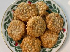 some cookies are on a plate with holly decorations