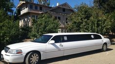 a white limousine parked in front of a house