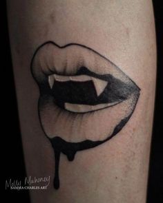 a black and white photo of a woman's face with dripping lipstick on her leg