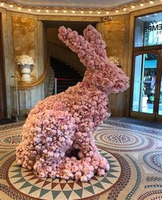 a rabbit made out of flowers in a lobby