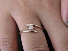 Dainty Ring Diamond 14k Solid Gold, Promise Ring Wedding Ring Diamond, Tiny Diamond Ring, Delicate Ring, Engagement Ring FREE SHIPPING Solid Gold Gold KT: solid gold 14k Gold color: White gold, rose gold, yellow gold Available in solid gold 18kt Diamond 100% natural diamond- Free conflict diamonds Diamond shape: Round Diamond size: Center 2.3 mm - Side 2 X 1.3mm Total weight: 0.07ct Number Stones: 3 Color: GH Clarity: VS.SI1 Width of band: 1.20 mm SIZING From 3US to 9US For other size, please co Simple Design Round Cut Diamond Ring For Anniversary, Adjustable Fine Jewelry Bypass Ring For Wedding, Fine Jewelry Anniversary Diamond Ring With Simple Design, Simple Adjustable Diamond Wedding Ring, Simple Open Ring Diamond Wedding Ring, Fine Jewelry Wedding Ring With Simple Design, Wedding 14k Rose Gold Bypass Ring, Simple Wedding Diamond Ring With Round Cut, Rose Gold Bypass Ring For Wedding