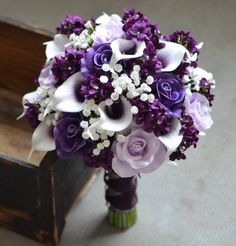 a bridal bouquet with purple and white flowers