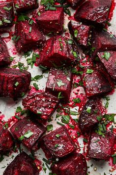 roasted beets with herbs and seasoning on a baking sheet