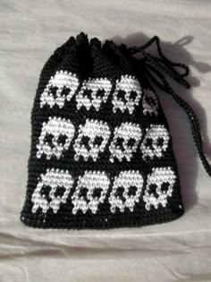 a black and white crocheted bag with the words happy new year written on it