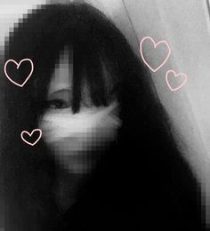 a woman with long black hair has hearts drawn on her face