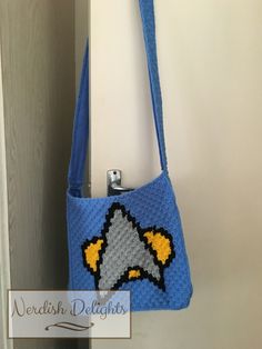 a crocheted bag hanging from a hook on a door handle with a sign that reads wedish delights