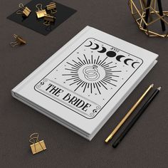 an open book with the title'the bride'on it next to some gold and black items