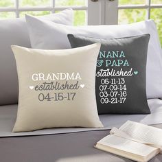 two pillows on a bed with the words grandma established