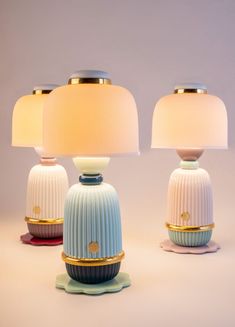 three colorful lamps sitting next to each other