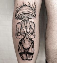 a man's leg with a tattoo on it and a mushroom above his head