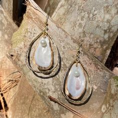 Unique oyster shell gold teardrop hoop earrings with round pearl. Small oyster is gold backed with gold outline on front. Hoop size is 2 inches in length by 1 1/4 in width which does not include the drop length. These earrings are light weight and can be dressed up or worn casual. Oyster shells are found in coastal Georgia. Each oyster is unique in color, shape and size. I will be happy to send a picture of the exact earrings before you purchase them. I also create custom orders. Gold Pearl Teardrop Earrings With Pearl Drop, Gold Teardrop Pearl Earrings For Pierced Ears, Gold Pearl Teardrop Dangle Earrings, Gold Teardrop Pearl Earrings With Pearl Charm, Gold Metal Hoop Earrings With Pearl Charm, Gold Teardrop Earrings With Pearl Charm, Teardrop Pearl Earrings With Metal Ear Wire, Gold Brass Hoop Earrings With Pearl Drop, Gold Teardrop Earrings With Pearl Drop