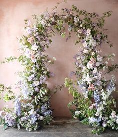 an arch made out of flowers and greenery