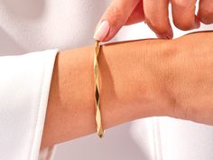 Crafted from the finest 14k gold, this bangle showcases a sleek, avant-garde geometric design. The clean lines and bold shapes make a powerful statement, turning your wrist into a canvas of modern sophistication. Wear it solo for a minimalist yet impactful look, or stack it with other bracelets to curate your unique style narrative.Features• Made to Order• Gold Kt: 14K• Gold Colors: Rose Gold, Yellow Gold, White Gold• Width: 3.70 mm• Thickness: 3.00 mm Modern Gold Bracelet With Polished Finish, Modern Cuff Bangle Bracelet, Modern Twist Cuff Bracelet Bangle For Formal Occasions, Modern Twist Bangle Cuff Bracelet For Formal Occasions, Modern Adjustable 14k Gold Bracelet, Modern Twist Cuff Bracelet For Formal Occasions, Modern 14k Gold Bangle Bracelets, Modern Polished Bangle For Formal Occasions, Modern Yellow Gold Tarnish Resistant Bracelet