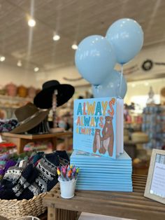 there are balloons and books on the table