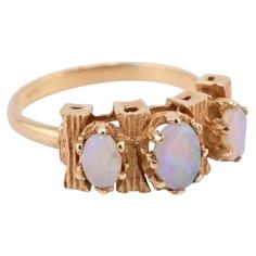 two gold rings with opal stones on them