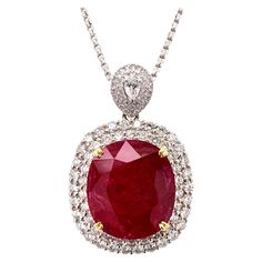 Glamorous large ruby diamond pendant necklace. Intense fiery red, high luster, cushion faceted, 24.21 carats natural ruby mounted in high profile with yellow gold eight knife prongs, accented with two rows of round brilliant cut diamonds, bail with pear faceted and cluster diamonds. Beautiful handcrafted design set in 18 karats. Chain is not included. Statement piece! Ruby: 24.21 carats, intense fiery red, high luster, cushion faceted Diamond: 3.45 carats, round brilliant cut Color: G-H Clarity: Luxury Ruby Necklaces With Polished Finish, Luxury Red Necklace With Prong Setting, Luxury Ruby Teardrop Pendant Jewelry, Luxury Ruby Faceted Necklaces, Luxury Red Necklaces With Single Cut Diamonds, Luxury Red Brilliant Cut Necklace, Ruby Diamond Pendant, Ruby Diamond Necklace, Pink Diamond Earrings