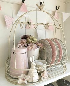 a white shelf with plates and cups on it