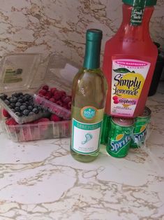 fruit, yogurt and wine are sitting on the counter top next to each other