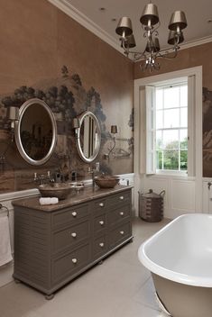 a bathroom with two sinks and a bathtub in front of a painting on the wall