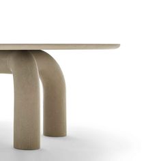 the table is made out of concrete and has two curved legs