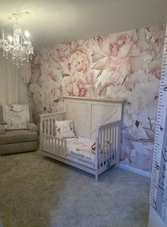 a baby's room with floral wallpaper and crib