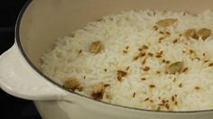 white rice with nuts in a pot on the stove