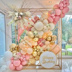 balloons are arranged in the shape of a pyramid on top of a gold and pink stand