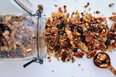 granola mix in a glass jar next to a wooden spoon