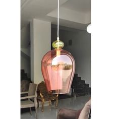 a pink lamp hanging from the ceiling in a living room