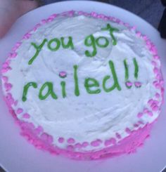 a birthday cake with the words you got nailed written on it in green and pink frosting