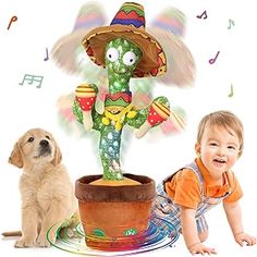 a baby and a dog sitting next to each other in front of a potted plant