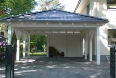 a white and blue gazebo sitting in the middle of a driveway