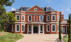 a large red brick house with white trim