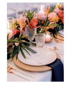 a table set with flowers and candles for an elegant dinner or party setting in shades of pink, orange and yellow