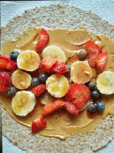 some fruit and peanut butter are on a tortilla